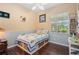 Cozy bedroom with hardwood floors and a window overlooking a beautiful yard at 1520 Dorgali Dr, Sarasota, FL 34238