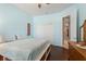 Bedroom with light blue walls, hardwood floors, a ceiling fan, and a closet at 1520 Dorgali Dr, Sarasota, FL 34238