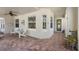 Inviting front porch featuring brick flooring and comfortable seating with ample space for relaxing outdoors at 1520 Dorgali Dr, Sarasota, FL 34238