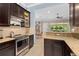 Beautiful kitchen with stainless steel appliances and dark wood cabinets, plus an eat-in area at 1520 Dorgali Dr, Sarasota, FL 34238