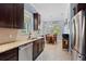 Well-equipped kitchen with stainless appliances, granite counters, and open layout to the dining area at 1520 Dorgali Dr, Sarasota, FL 34238