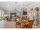 Open living and dining area with access to the sunroom at 1520 Dorgali Dr, Sarasota, FL 34238