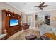 Cozy living room featuring a large entertainment center and comfortable furnishings at 1520 Dorgali Dr, Sarasota, FL 34238