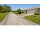 Pleasant street view with well-kept homes, paved driveways, and manicured lawns in a tidy neighborhood at 1520 Dorgali Dr, Sarasota, FL 34238