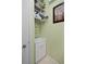Small utility sink with shelving in an utility room at 1520 Dorgali Dr, Sarasota, FL 34238