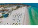 Stunning aerial view of beachfront condos, tennis court, and white sand beach with turquoise water at 1724 Cheyenne St, Sarasota, FL 34231