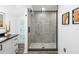 Updated bathroom featuring a glass-enclosed shower with decorative tile accents and modern fixtures at 1724 Cheyenne St, Sarasota, FL 34231