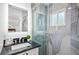 Modern bathroom with a black granite vanity, shower with sliding glass doors and tiled walls at 1724 Cheyenne St, Sarasota, FL 34231