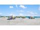 Picturesque beach scene with white sand, blue skies, and numerous colorful sun umbrellas for a relaxing getaway at 1724 Cheyenne St, Sarasota, FL 34231