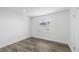Bright bedroom features wood-look flooring, white walls, and a window with natural light at 1724 Cheyenne St, Sarasota, FL 34231