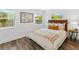 Inviting bedroom with light walls, wood-look flooring, and bright windows offering lots of natural light at 1724 Cheyenne St, Sarasota, FL 34231