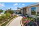 Beautifully landscaped front yard with a curving walkway leading to the front door, with tasteful plantings and garden edging at 1724 Cheyenne St, Sarasota, FL 34231