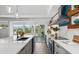 Modern kitchen featuring quartz countertops, stainless steel appliances, and a view of the outdoor pool area at 1724 Cheyenne St, Sarasota, FL 34231