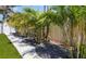 Beautifully landscaped yard featuring palm trees, white rocks, black mulch, and artificial turf for a clean, modern look at 1724 Cheyenne St, Sarasota, FL 34231