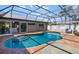 Enclosed pool with a clear blue swimming pool, brick pool deck and outdoor furniture at 1724 Cheyenne St, Sarasota, FL 34231