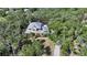 Aerial view of a charming two-story home with colorful landscaping and a metal roof at 1788 Palm View Rd, Sarasota, FL 34240