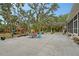 Spacious backyard with a patio, outdoor seating, playset, and lush landscaping, perfect for Gathering activities at 1788 Palm View Rd, Sarasota, FL 34240