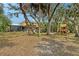 Beautiful backyard featuring ample space, mature trees, and an inviting outdoor patio at 1788 Palm View Rd, Sarasota, FL 34240