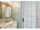 Stylish bathroom featuring marble vanity top, unique gold-trimmed mirror, and elegant fixtures at 1788 Palm View Rd, Sarasota, FL 34240