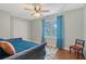 Comfortable bedroom with hardwood floors, a cozy daybed, and a window with patterned curtains at 1788 Palm View Rd, Sarasota, FL 34240