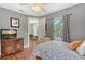 Cozy bedroom with hardwood floors, ceiling fan and modern furniture at 1788 Palm View Rd, Sarasota, FL 34240