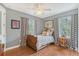 Charming bedroom with natural light, hardwood floors, and modern decor at 1788 Palm View Rd, Sarasota, FL 34240