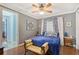 Bedroom features a blue comforter, hardwood floors, and elegant decor at 1788 Palm View Rd, Sarasota, FL 34240