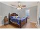 Bedroom featuring a wooden bed frame, tile floors, and decorative ceiling fan with lighting at 1788 Palm View Rd, Sarasota, FL 34240