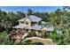 Charming two-story home featuring colorful landscaping and a metal roof at 1788 Palm View Rd, Sarasota, FL 34240