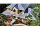 Charming two-story home featuring colorful landscaping and a metal roof at 1788 Palm View Rd, Sarasota, FL 34240