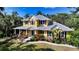 Charming two-story home featuring colorful landscaping and a metal roof at 1788 Palm View Rd, Sarasota, FL 34240