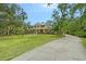 Charming two-story home featuring colorful landscaping and a long driveway at 1788 Palm View Rd, Sarasota, FL 34240