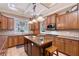 A well-equipped kitchen with wood cabinets and island, modern appliances, and recessed lighting at 1788 Palm View Rd, Sarasota, FL 34240