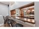 Stylish kitchen bar area with granite countertops and pendant lighting, providing a cozy dining space at 1788 Palm View Rd, Sarasota, FL 34240