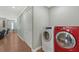 Convenient laundry area showcasing modern appliances along hallway and closet at 1788 Palm View Rd, Sarasota, FL 34240