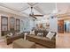 Cozy living room featuring a stone fireplace, tray ceiling, and tiled floors at 1788 Palm View Rd, Sarasota, FL 34240