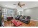 Living room with hardwood floors, ceiling fan, and classic leather recliners at 1788 Palm View Rd, Sarasota, FL 34240