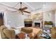 Comfortable living room featuring a stone fireplace, tile floor, and tray ceiling at 1788 Palm View Rd, Sarasota, FL 34240