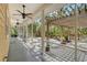 Relaxing screened porch with ceiling fans overlooking a lush backyard with a patio and playground at 1788 Palm View Rd, Sarasota, FL 34240