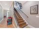 Stylish staircase with wooden steps, iron railing, and decorative accents, adding charm to the home's interior at 1788 Palm View Rd, Sarasota, FL 34240