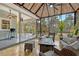 Relaxing sunroom with tile floor, comfortable seating, and screened windows overlooking the spacious backyard at 1788 Palm View Rd, Sarasota, FL 34240