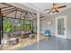 Cozy sunroom with comfortable seating, string lights, ceiling fans, and screened windows to bring the outdoors in at 1788 Palm View Rd, Sarasota, FL 34240