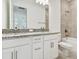Bathroom featuring double sinks, granite countertops, and a tiled shower/tub at 18016 Cherished Loop, Bradenton, FL 34211