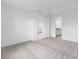 A bedroom with an open door, a bathroom, and a carpeted floor at 18016 Cherished Loop, Bradenton, FL 34211