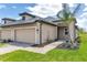 Charming single-story home with a neutral color palette, a tile roof, an attached garage and a meticulously landscaped front yard at 18016 Cherished Loop, Bradenton, FL 34211