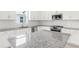 Close up of Bright kitchen with large island and stainless steel appliances at 18016 Cherished Loop, Bradenton, FL 34211