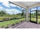 Enjoy scenic views from this screened-in patio, featuring brick floors and an access door at 18016 Cherished Loop, Bradenton, FL 34211