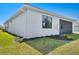 Backyard featuring a white exterior and green grass at 18525 Midsummer Pl, Venice, FL 34293