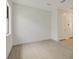 Unfurnished bedroom featuring neutral tile flooring, white walls, recessed lighting and a large window at 18525 Midsummer Pl, Venice, FL 34293