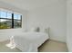 Bright bedroom with a large window, allowing natural light and exterior view at 18525 Midsummer Pl, Venice, FL 34293